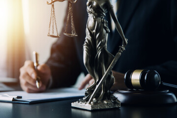 Business and lawyers discussing contract papers with brass scale on desk in office. Law, legal services, advice, justice and law concept picture with film grain effect