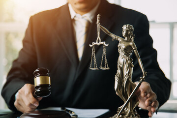 Business and lawyers discussing contract papers with brass scale on desk in office. Law, legal...