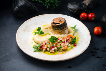 Smoked mackerel fillet with mashed potatoes, fresh salad with cucumber, radish and tomato and greens.