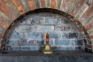 Bell in an engineering brick alcove