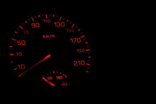 Illuminated car speedometer isolated on black background. The automotive concept with an empty space for your text