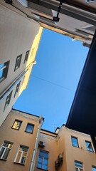 View of inner courtyard well in old historical part of St. Petersburg against blue sky, Saint Petersburg, Russia. High quality photo
