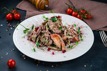 Georgian salad with cucumbers, cherry tomatoes, onion, pomegranate seeds and herbs in walnut dressing.