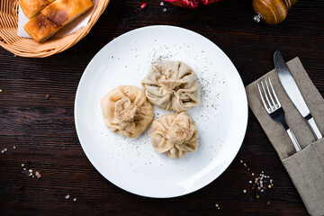 Asian cuisine manti with meat, pepper and bread.
