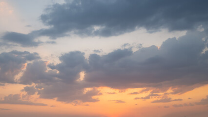 Naklejka na ściany i meble Orange blue sky with clouds at beautiful sunset as natural background.