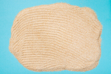 Yellow sand pattern close up on a blue background