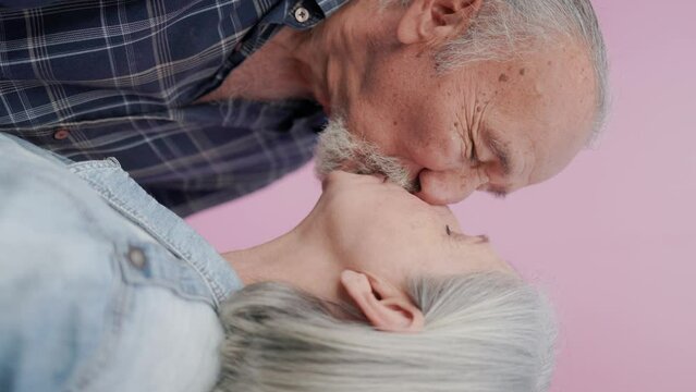 Happy senior couple kissing in love outdoors - Joyful elderly and family lifestyle concept