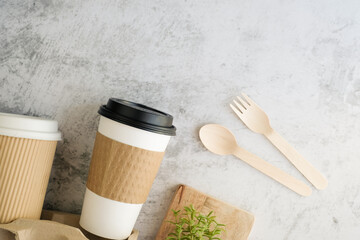 Fototapeta na wymiar paper take away coffee with lid includes wood or bamboo utensils with copy space. flatlay , top view.