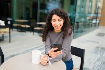 Beautiful woman using her mobile phone at the coffee shop