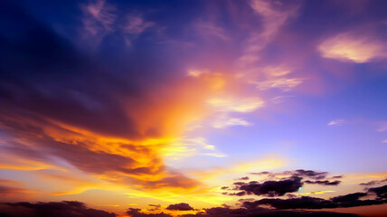 Fototapeta premium Beautiful sunset sky filled with warm shades of orange, pink, and purple, the soft, wispy clouds, background, wallpaper.