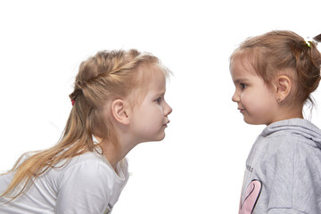 Children look at each other, pierced ears and without piercing. the concept of choice.