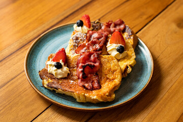 French toast with artisan bread, strawberries, blueberries and maple syrup