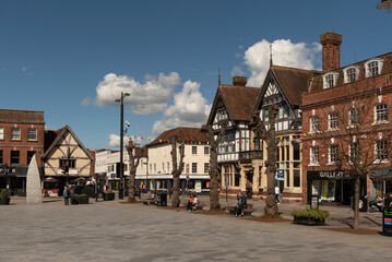 Salisbury, Wiltshire, England, UK. 2023. People walk on Market Place in the city centre surrounded...