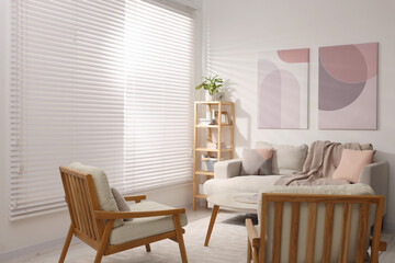 Stylish living room interior with sofa, coffee table and armchairs