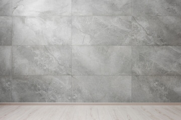 Empty room with grey marble wall and wooden floor