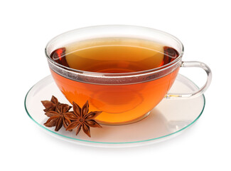 Glass cup of hot tea with anise stars on white background