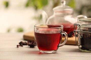 Delicious hibiscus tea on white wooden table