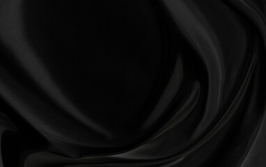 Black gray satin dark fabric texture luxurious shiny that is abstract silk cloth background with patterns soft waves blur beautiful.