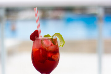 Refreshing strawberry cocktail with lemon peels
