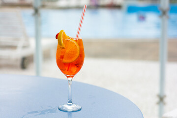 Refreshing summer day: Tropical gin with orange and strawberry in a glass.