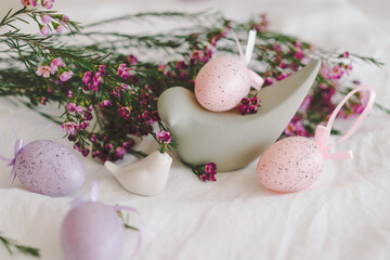 Easter eggs with flowers on white linen fabric. Spring and Easter concept.