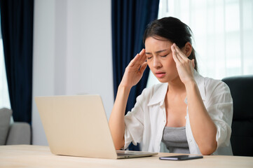 Office syndrome. Overworked tired young asian woman feeling headache, having eyesight problem after computer laptop work. Stressed young woman suffering from fatigue at home