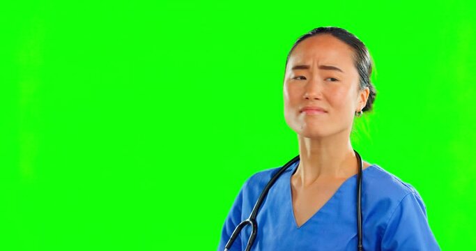 Healthcare, green screen and a nurse swatting or dodging flies in studio on a chromakey background. Medical, mockup and annoyed with a female asian medicine professional hitting blank or empty space
