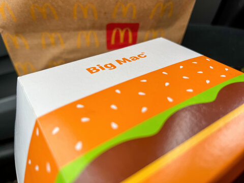 GERMANY - APR 06, 2023: McDonald's Big Mac as a quick on-the-go snack in the car