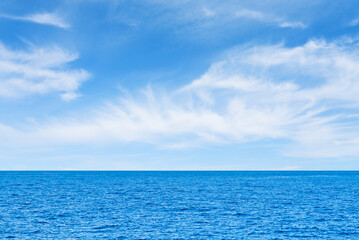 Obraz na płótnie Canvas Blue sea and white clouds on sky. Water cloud horizon background. Feeling calm, cool, relaxing. The idea for cold background and copy space on the top. the ocean deep indigo