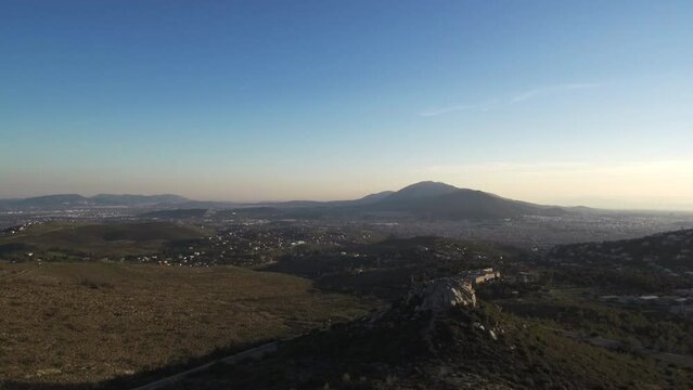 Cinematic drone shot view of mount Himittos in Athens Greece during sunset