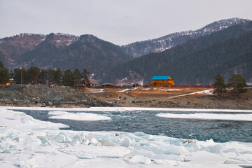 Rapids of Altai river Katun with banks covered by ice and snow in winter season near Elekmonar settlement.