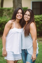 Obraz premium Smiling mid aged hispanic siblings posing at their backyard. Generative AI 