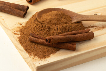 Cinnamon powder and sticks. Selective focus.