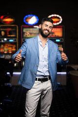 Portrait of Man in Casino Showing Thumbs Up