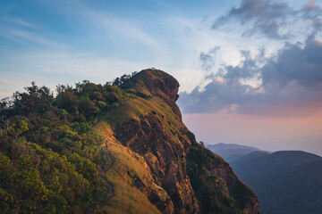 A women standing on the back of lion mountain in the northern of Thailand (Mon Chong Mt. Chiang Mai province)