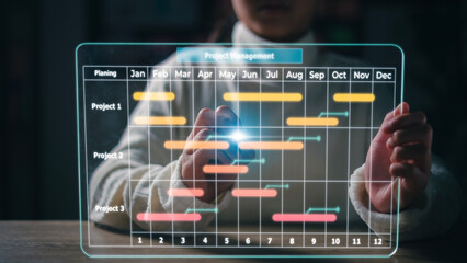 Project manager working on futuristic virtual interface screen. and updating tasks and milestones progress planning with Gantt chart scheduling interface. Business Project Management System.