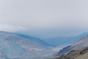 rolling hills and clouds on the top of the mountain at Ladakh, Leh, India