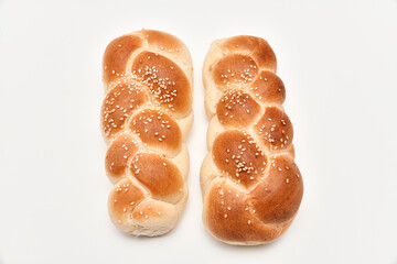 Braided bun with sesame seeds on white background