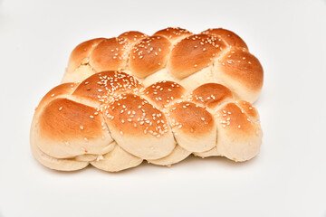 Braided bun with sesame seeds on white background