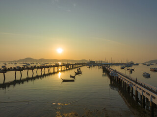 aerial view beautiful sunrise cloud above Chalong pier..Sunrise with sweet yellow color light rays and other atmospheric effects..colorful reflection of sunrise in the sea background.