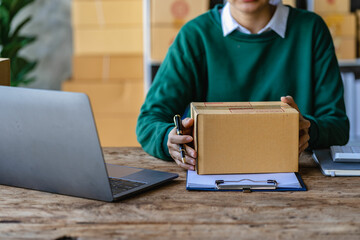 Small Business Startup SME Owner Asian Woman Checking Online Orders Sell ​​goods, work with boxes. home office freelance work online sme business delivery concept