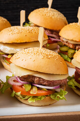 small burgers on the catering table