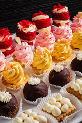 Pastry shop display window with variety of mini desserts and cakes