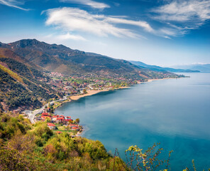 Colorful spring cityscape of Pogradec town. Sunny morning scene of Ohrid lake. Breathtaking...