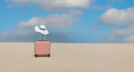 Pink of the luggage  with white hat on the beach- summer travel concept