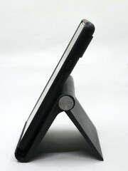 a smartphone placed on an adjustable mobile holder stand at an angle isolated in a white background