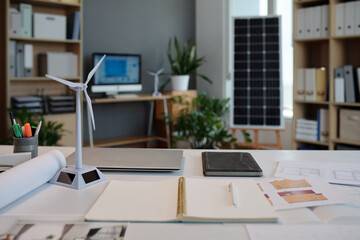 Opened planner on desk of engineer planning green energy home project