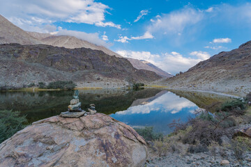 Fototapeta na wymiar Tibetan praying stack stone beside Lake Yarab Tso - Leh Ladakh - India