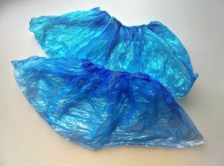 Fototapeta premium blue hygienic shoe covers on a light background