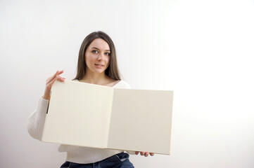 Portrait of a young woman with blank billboard isolated on white background. High quality photo